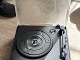 a record player sitting on the floor next to a pair of shoes