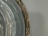 a glass bowl with a silver rim on a table