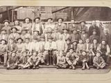 an old photo of a group of people posing for a picture