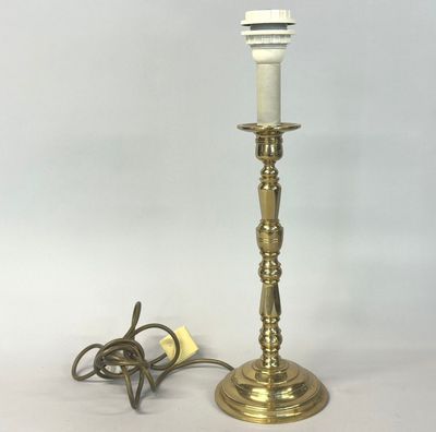 an image of a brass table lamp with a cord plugged into it