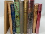 books are lined up in a row on a white surface