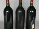 three bottles of wine are lined up on a table