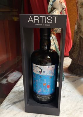 a bottle of wine that is in a box on a table