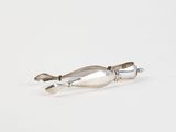 silver plated spoon and spoon rest on a white surface