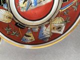 a plate with a picture of a woman and a cat on it