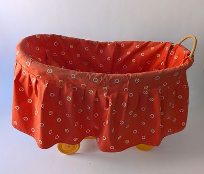 a red basket with yellow wheels on a white background