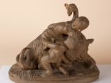 statue of a woman on a buffalo on a white surface
