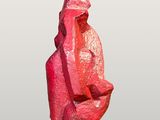pink sculpture of a man sitting on his knees with a hat on his head