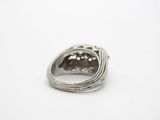 a close up of a silver ring on a white surface