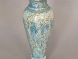 a blue vase that is sitting on a table