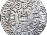 a close up of a silver coin with a design on it