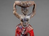 an image of a statue of a woman holding a basket on her head