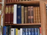a book shelf with many books on it in a room
