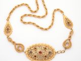 an image of a gold necklace with multi colored stones on it