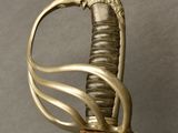 an old sword with a gold handle and a lion head on it