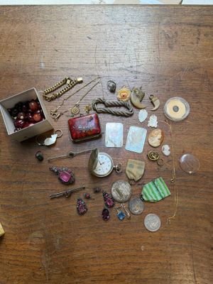 a wooden table with a box of jewelry on it
