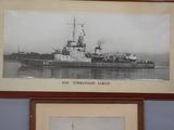 a framed picture of a ship on display in a room