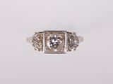 a close up of a diamond ring on a white surface