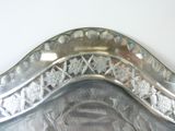 a silver plate with a decorative design on it