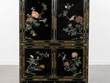 an image of a black cabinet with flowers and birds painted on it