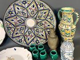 many different types of pottery on display on a table