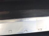 a silver toaster sitting on a black table