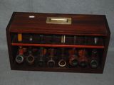 a wooden box with a bunch of pipes inside of it