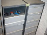 a metal cabinet with a drawer in the middle of it