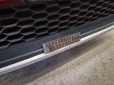 a close up of a car ' s grille with a ruler on it