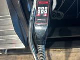 a close up of a metal object with a cord attached to it