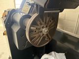 an image of a machine that is working on a piece of metal