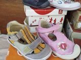 a pile of children ' s shoes on top of each other