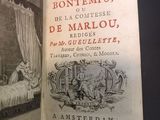 an old book with a picture of a woman in a bed