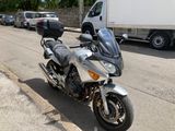 a silver motorcycle parked on the side of the road