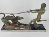 statue of a boy pulling a duck with a sleigh on a marble base