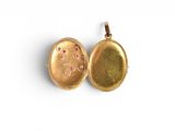 a close up of two gold lockes on a white surface