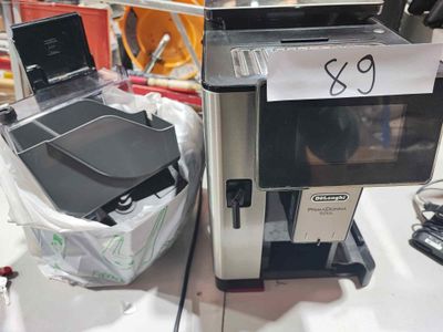 a coffee machine and a laptop sitting on a counter