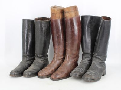 four pairs of boots are lined up in a row on a white background