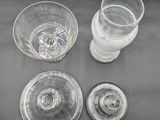three glasses and a bottle of water sitting on a table