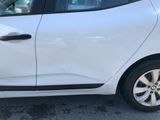 a white car parked in a parking lot next to a building
