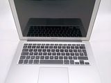 a laptop computer sitting on top of a white table