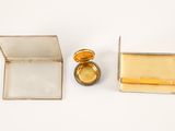 a small box that has a gold ring inside of it