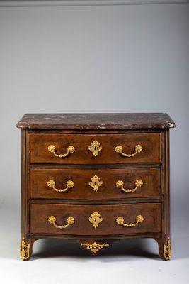 an antique chest of drawers with marble top and brass handles