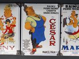 three posters of various cartoon characters are hanging on a wall