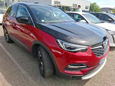 a red and black car parked in a parking lot