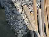 a white truck parked next to a pile of wood