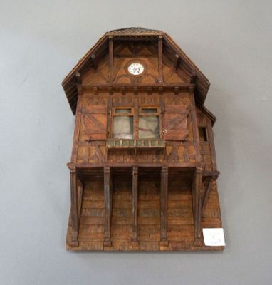 a clock on the wall of a wooden house