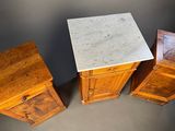 three pieces of furniture with a marble top and wooden drawers