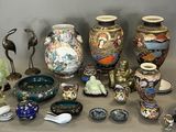 many different vases and bowls sitting on a table