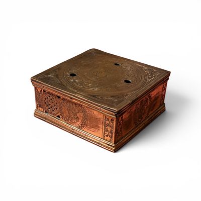 a wooden box with carvings on it on a white surface